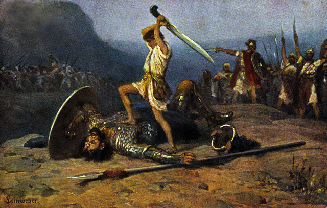David rests his foot over Goliath, having been knocked down by his rock. David raises a sword above his head, ready to behead Goliath. Behind him, solders stand in awe.